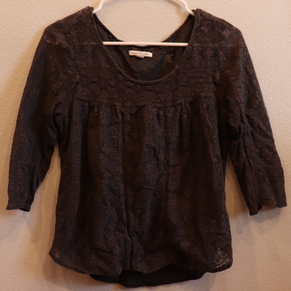 Grey patterned blouse, slightly see through.